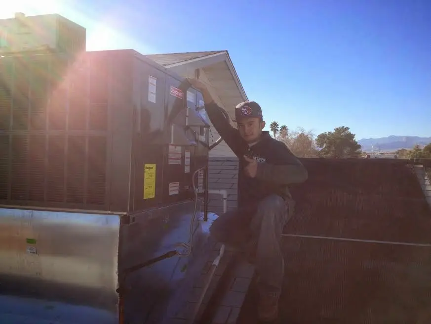 HVAC technician performing Boiler Repair on a rooftop unit in Reading